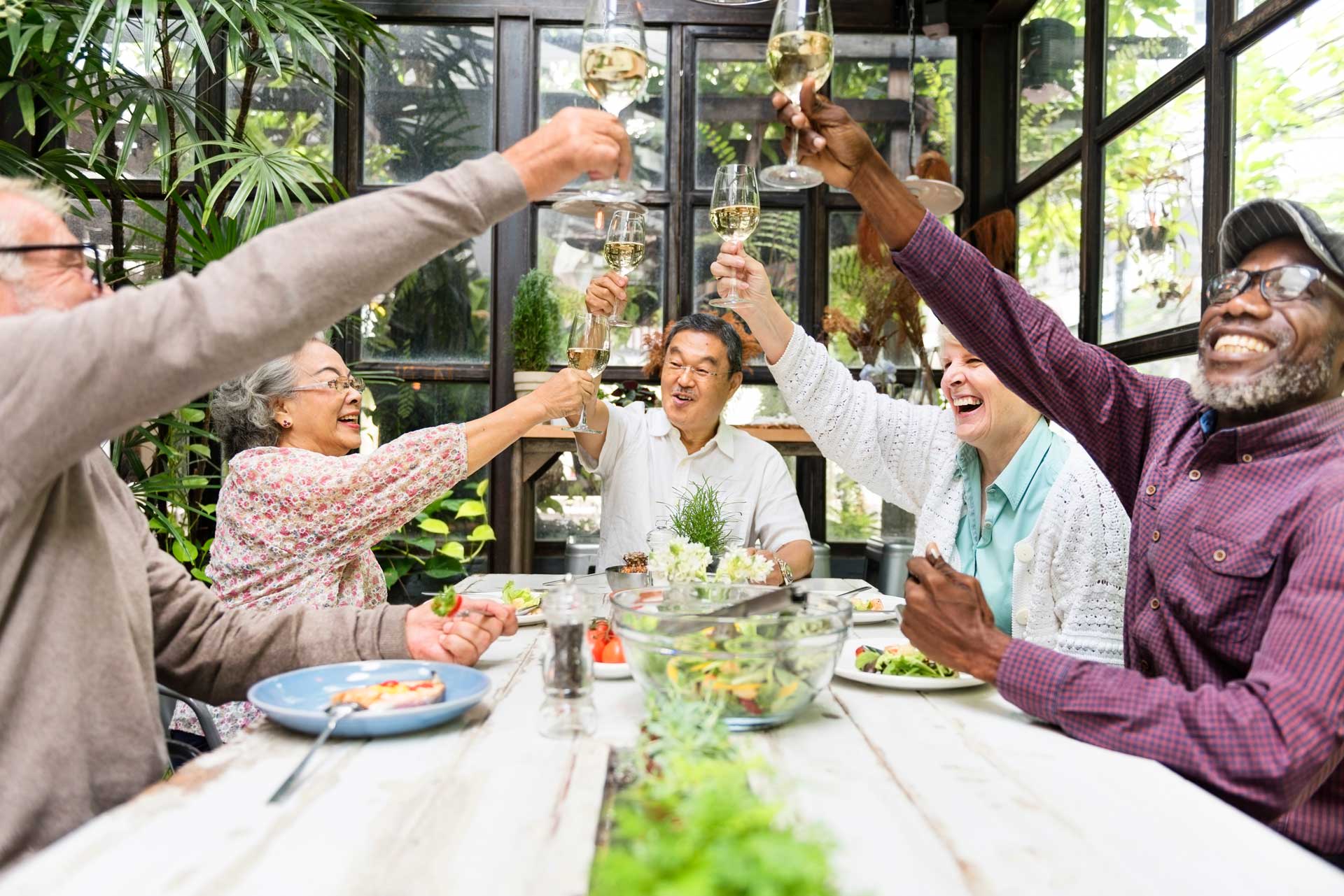 A group of seniors post together around a table